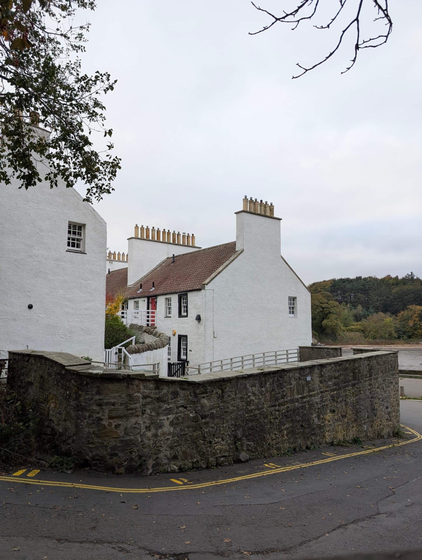 White cottages with terracotta roofs beside a Scottish estuary